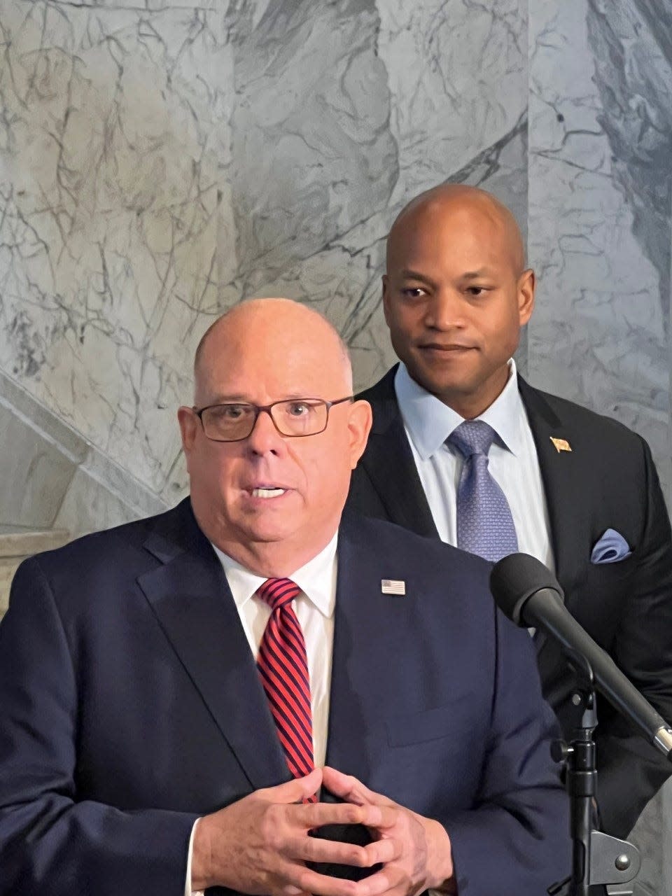Governor Larry Hogan, left, speaks to reporters at the State House in Annapolis on Nov. 10, 2022, as Governor-Elect, right, looks on.