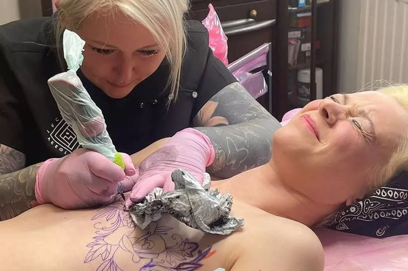 Lucy tattoos the chest of a client who had mastectomy surgery