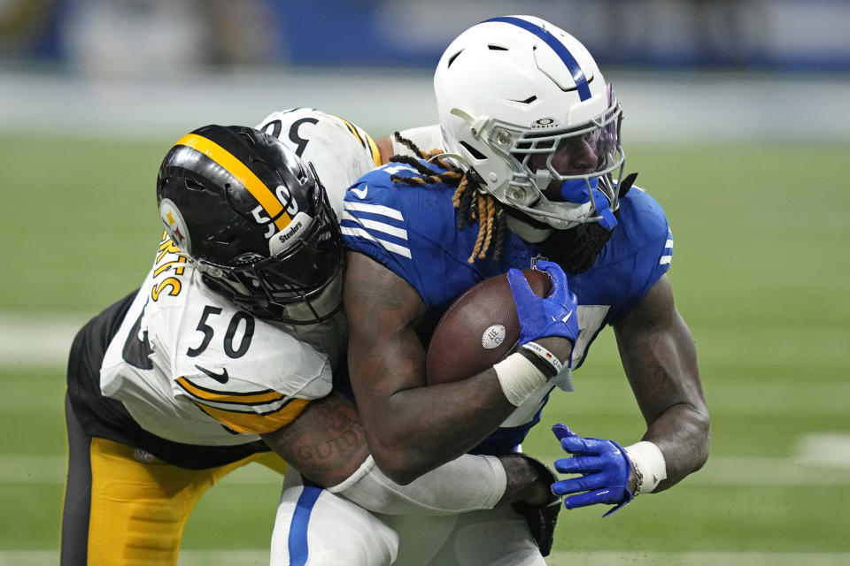 Indianapolis Colts running back Trey Sermon (27) is tackled by Pittsburgh Steelers linebacker Elandon Roberts (50) during the second half of an NFL football game in Indianapolis on Saturday, Dec. 16, 2023. (AP Photo/Michael Conroy)