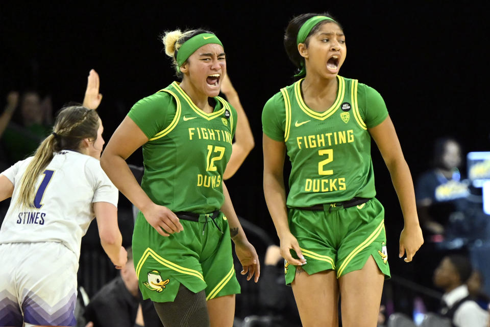 Oregon guard Te-Hina Paopao (12) and guard Chance Gray (2) react after a three-point basket against Washington during the second half of an NCAA college basketball game in the first round of the Pac-12 women's tournament Wednesday, March 1, 2023, in Las Vegas. (AP Photo/David Becker)