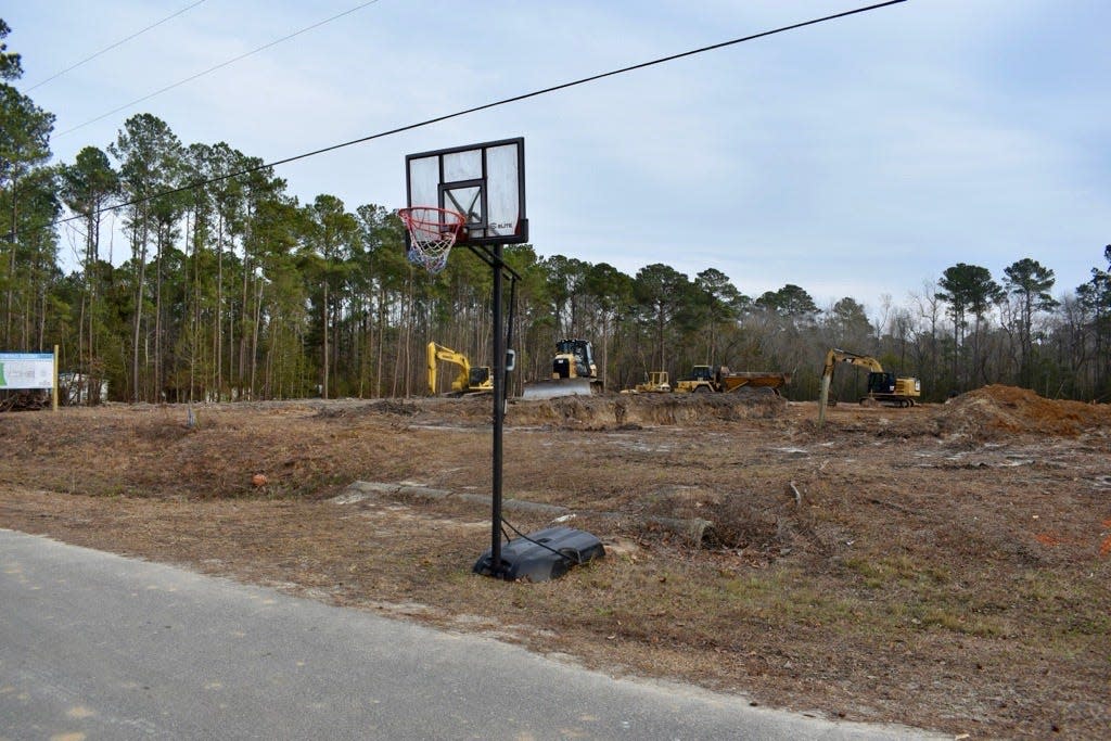 This makeshift basketball court -- a hoop sitting on the edge of Highland Hills Drive NE in Leland -- will soon be replaced with a true basketball court, one that will be part of a 10-home Brunswick County Habitat for Humanity subdivision.