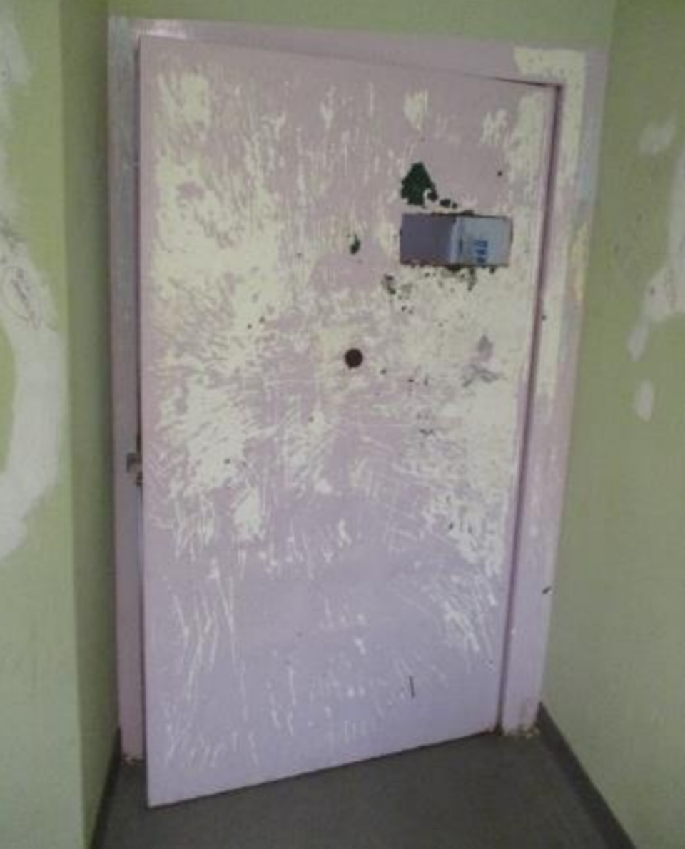 Extensive scratching can be seen on one of the cell doors (HM inspectorate of prisons)