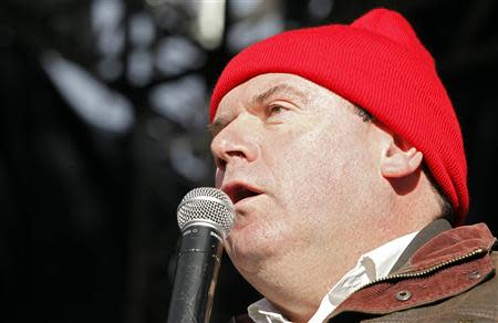 Christian Troadec, founder of the Breton red bonnet movement, addresses demonstrators during a rally calling for the maintaining of jobs in the region and against an "ecotax" on commercial trucks, in Carhaix, western France, November 30, 2013. REUTERS/Mal Langsdon