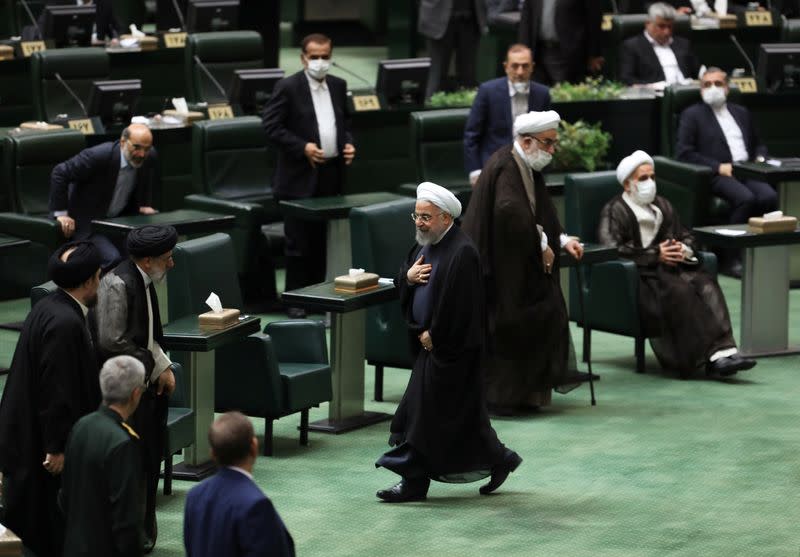 Iranian President Hassan Rouhani walks after delivering a speech on the opening ceremony of Iran's 11th parliament, as the spread of the coronavirus disease (COVID-19) continues, in Tehran