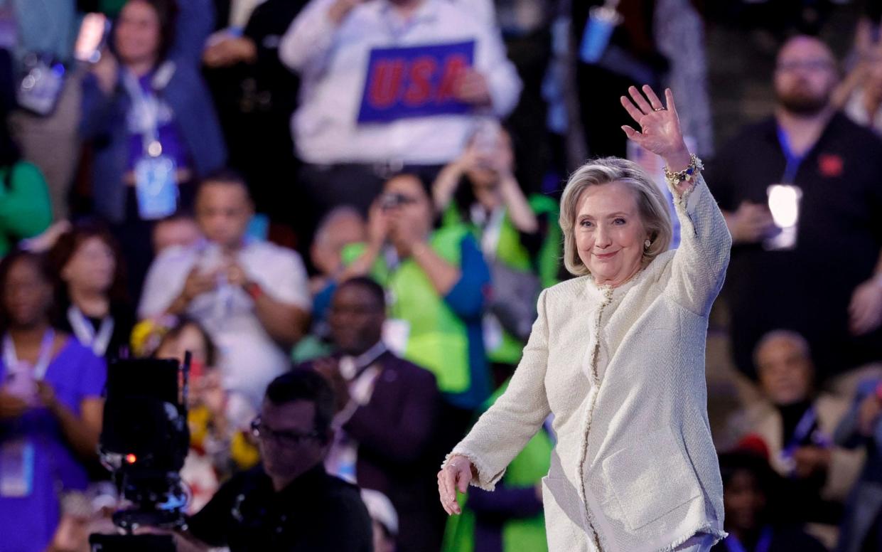 Hillary Clinton waves as she arrives on stage to speak on the first day of the Democratic National Convention