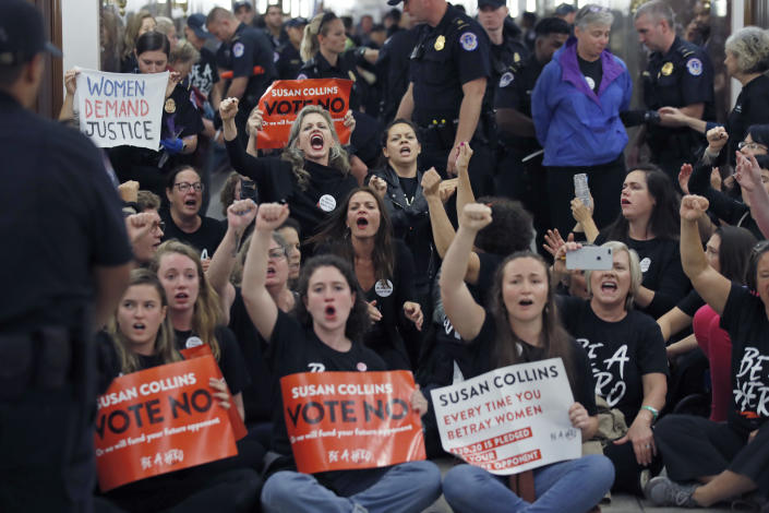 <p>Protesters sit in and chant against Judge Brett Kavanaugh as Capitol Hill police officers make arrests outside the office of Sen. Susan Collins, R-Maine, on Capitol Hill, Monday, Sept. 24, 2018, in Washington. (Photo: Alex Brandon/AP) </p>