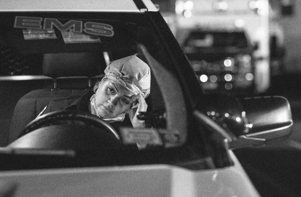 Image: Patricia Rodriguez, a paramedic, fills out reports after her 12-hour shift in Yonkers, N.Y., on April 6, 2020. (John Moore / Getty Images file)