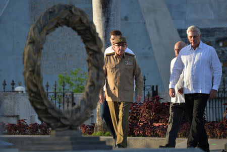 FILE PHOTO: Cuban First Secretary of Communist Party Raul Castro Ruz (C) and President Miguel Diaz-Canel (R) arrive to Santa Ifigenia Cemetery in Santiago de Cuba, on 01 January 2019, to celebrate the 60th Anniversary of Revolution. Yamil Lage/Pool via Reuters