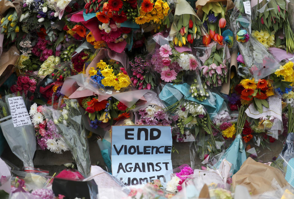 Floral tributes are placed at the bandstand in Clapham Common in London, Sunday, March 14, 2021 in memory of Sarah Everard who was abducted and murdered after last being seen walking home from a friend's apartment in south London on the night of March 3. London’s Metropolitan Police was under heavy pressure Sunday to explain its actions during a vigil for a woman whom one of the force's own officers is accused of murdering. Hundreds defied coronavirus restrictions to gather and protest violence against women, but the event ended with clashes between police and those attending. (AP Photo/Frank Augstein)