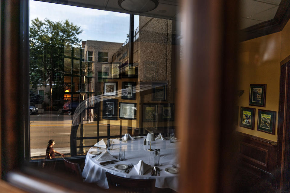 FILE - In this Aug. 20, 2020, file photo, a set table sits empty inside the closed Vince Lombardi's Steakhouse in Appleton, Wis. Stuffed into the new emergency relief package is a morsel that President Donald Trump has long had on the buffet of his economic wish list: restoring full tax breaks for restaurant business meals. (AP Photo/David Goldman, File)