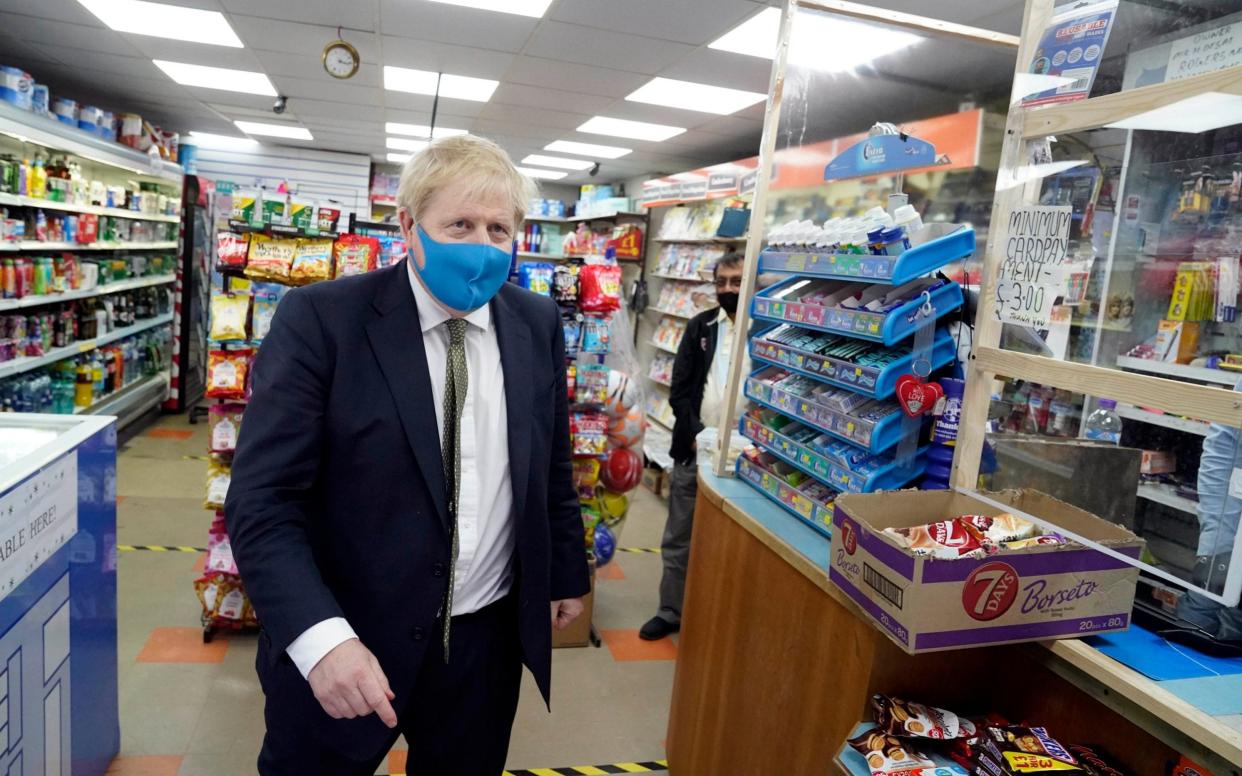 Mr Johnson was pictured in a Tory-blue mask during a constituency visit on Friday - Parsons Media