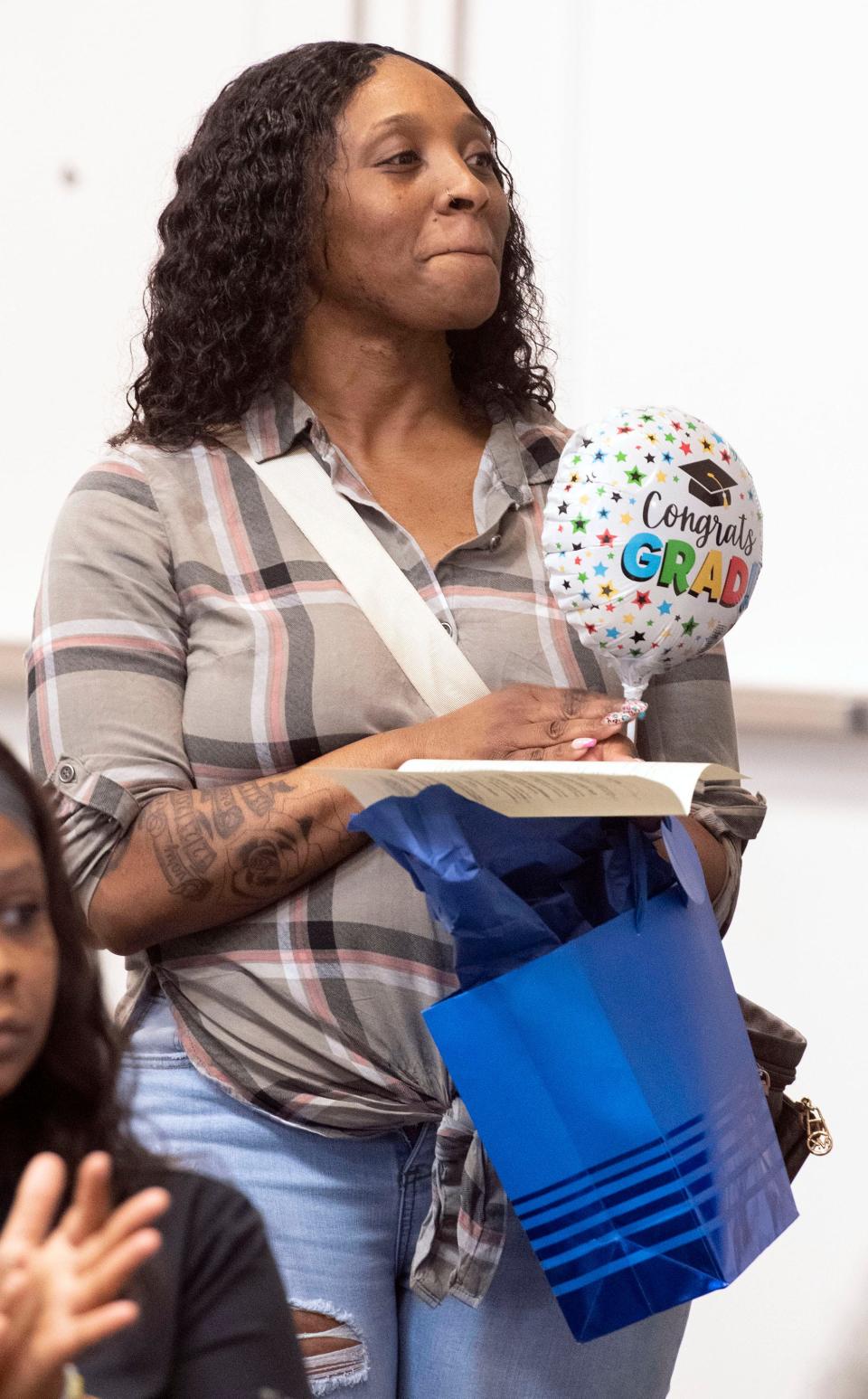 Pensacola Beach Holiday Inn employee Shanita Farmer shows support for a Project SEARCH graduate during a ceremony Wednesday at Hilton Pensacola Beach.