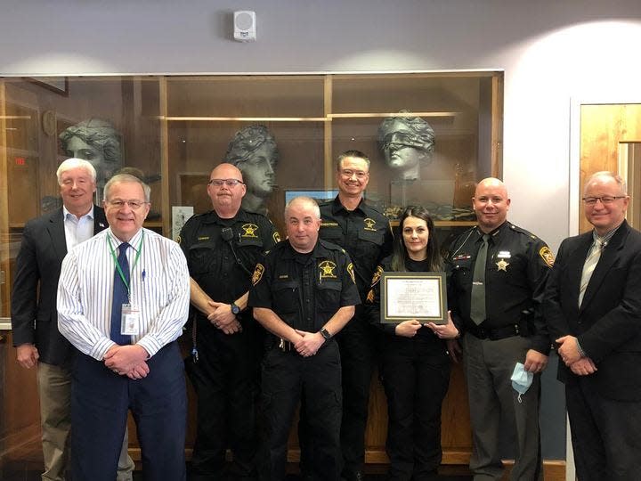 Tuscarawas County commissioners gave Sheriff Orvis Campbell and officers overseeing the county jail a certificate recognizing the facility's perfect score in its last state inspection. Shown from left to right are commissioners Al Landis and Kerry Metzger, Sgt. Larry Cannon, Sgt. Scott Goss, Lt. Ken Engstrom, Sgt. Kim Ledfors, Campbell and Commissioner Chris Abbuhl.