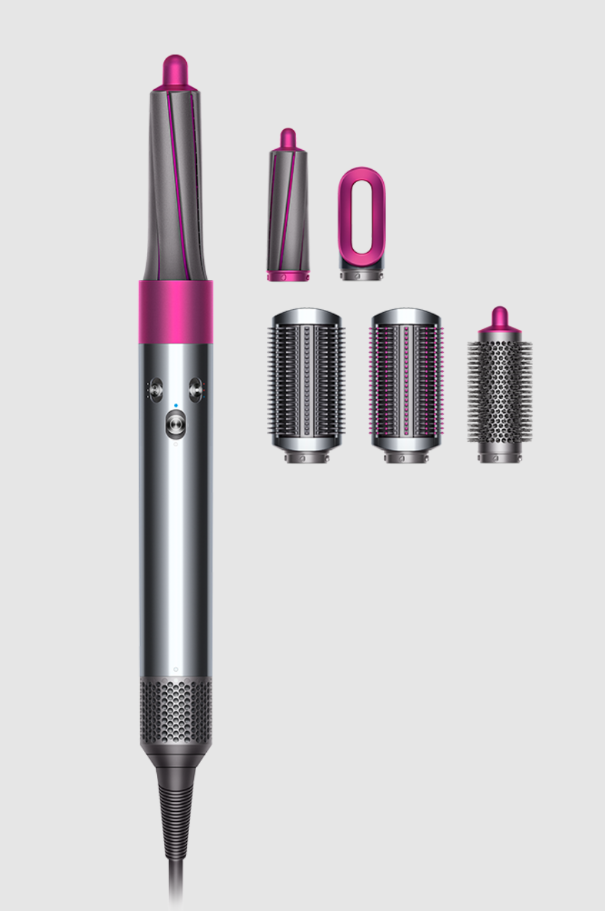 A pink and silver Dyson styling wand with five pink and silver attachments on a light background.