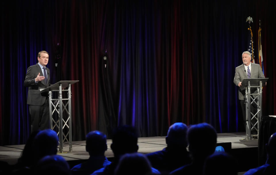 Democratic U.S. Sen. Michael Bennet, left, responds to a question during a debate with Republican challenger Joe O'Dea, Friday, Oct. 28, 2022, on the campus of Colorado State University in Fort Collins, Colo. (AP Photo/David Zalubowski)