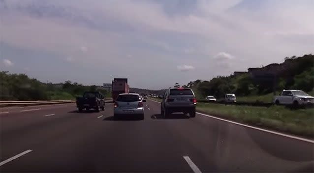 A BMW is centremetres away form hitting a Volswagen Polo on a busy highway. Picture: Ivan Leon