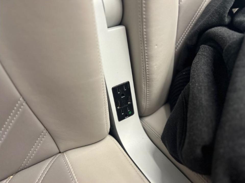 The outlet and USB ports in the Brightline seat.