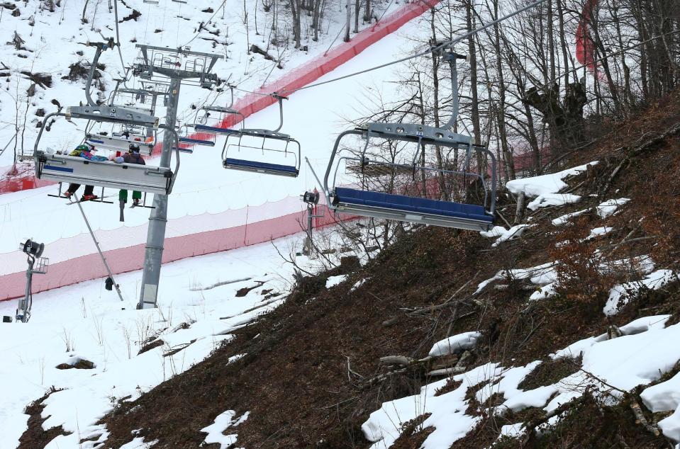 An inter-mingling of snow and brown patches are seen near the alpine course at the Sochi 2014 Winter Olympics, Tuesday, Feb. 11, 2014, in Krasnaya Polyana, Russia. Warm temperatures in the mountains made the snow too soft and caused the cancellation of Women's downhill training on Tuesday. (AP Photo/Alessandro Trovati)