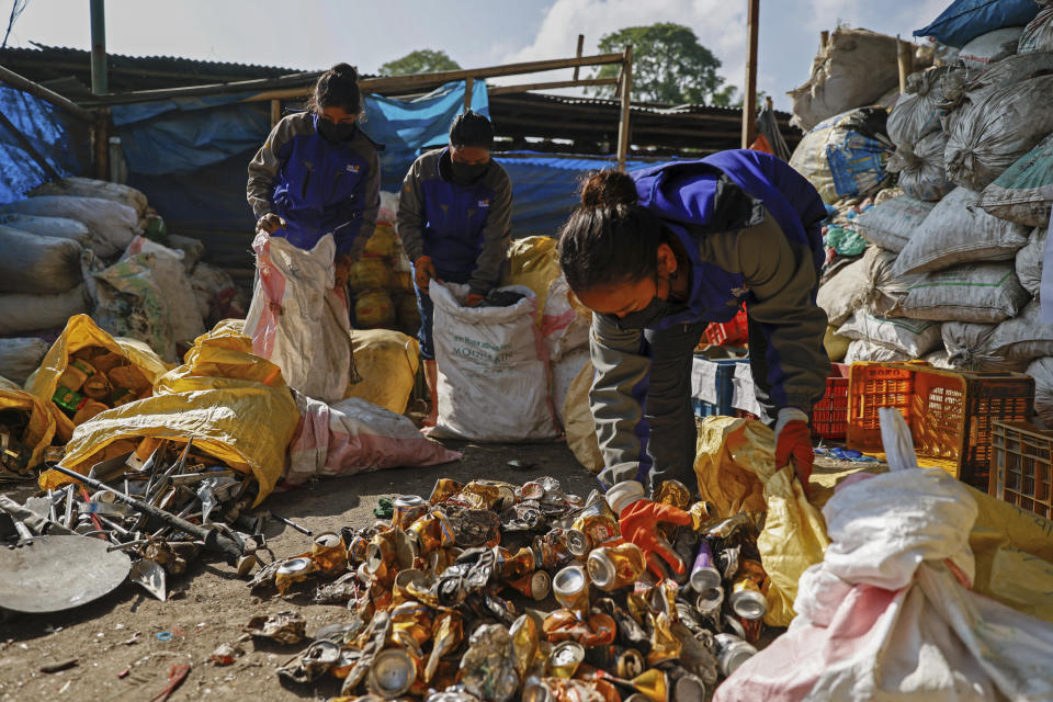 Workers segregate the garbage collected en route Mount Everest, at a facility operated by Agni Ventures, an agency that manages recyclable waste, in Kathmandu, Nepal, Monday, June 24, 2024. The Nepal government-funded team of soldiers and Sherpas removed 11 tons (24,000 pounds) of garbage, four dead bodies and a skeleton from Everest during this year's climbing season. (AP Photo/Sanjog Manandhar)