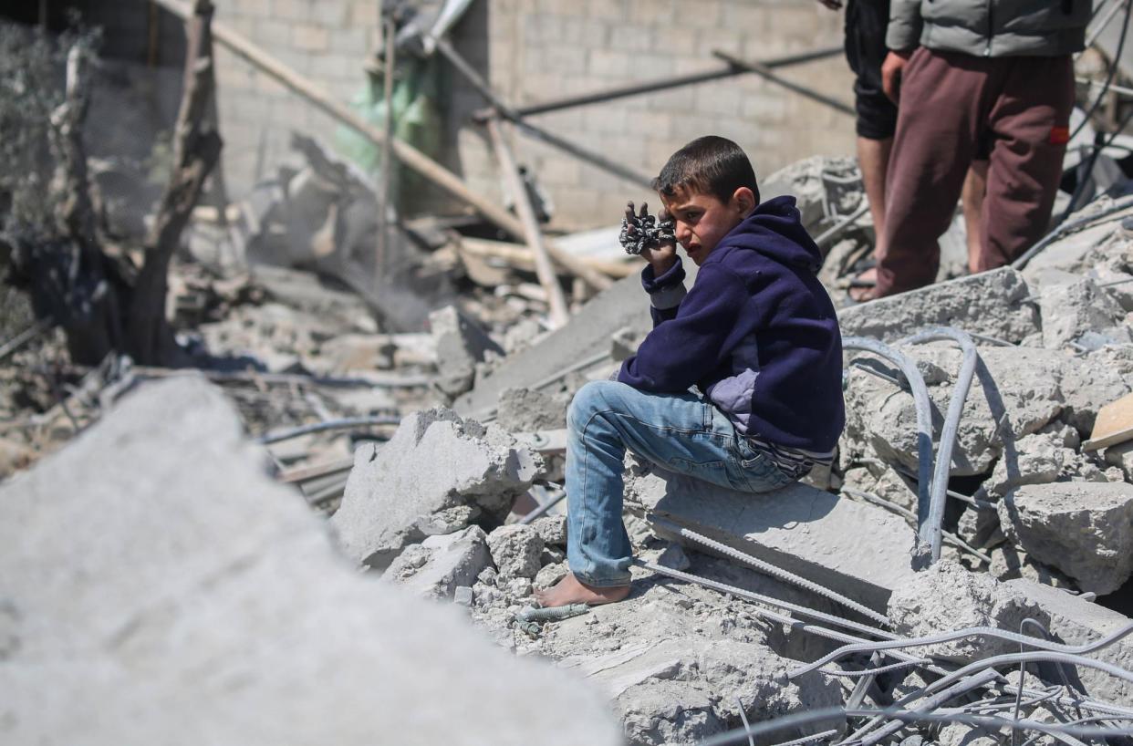 <span>People inspect damage and recover items from their homes following Israeli strikes in Rafah, Gaza, on 20 March 2024.</span><span>Photograph: Ahmad Hasaballah/Getty Images</span>