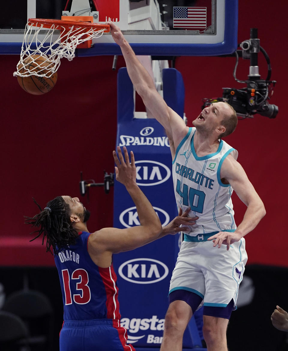 Charlotte Hornets center Cody Zeller (40) dunks on Detroit Pistons center Jahlil Okafor (13) during the second half of an NBA basketball game, Tuesday, May 4, 2021, in Detroit. (AP Photo/Carlos Osorio)