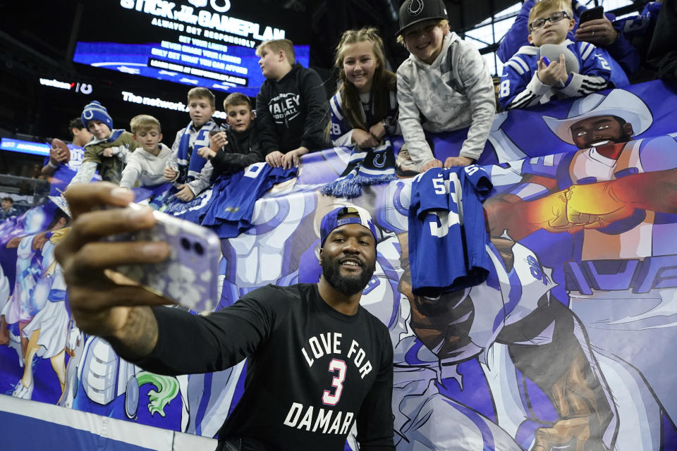 Indianapolis Colts linebacker Shaquille Leonard, wearing a shirt in support of Buffalo Bills safety Damar Hamlin, takes a photo with fans before an NFL football game between the Houston Texans and Indianapolis Colts, Sunday, Jan. 8, 2023, in Indianapolis. (AP Photo/Darron Cummings)