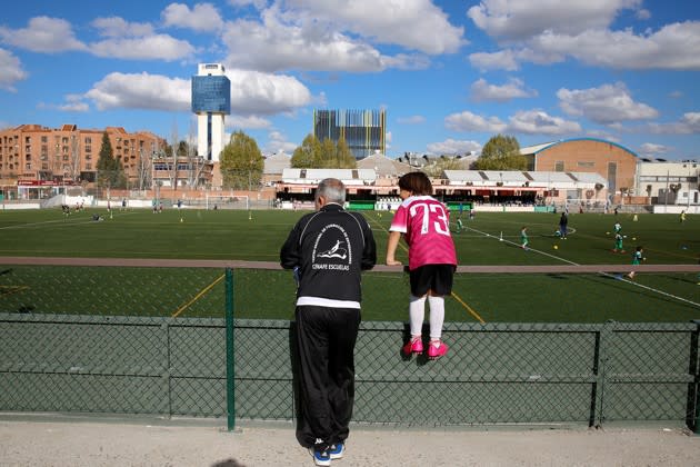 Osama Abdul Mohsen and his son Zaid, Syrian refugees who drew global attention last fall when a photo of a camerawoman tripping them went viral, watch a soccer training session in Madrid, Spain, on April 14, 2016. See more <a href="http://www.theatlantic.com/photo/2016/06/a-tripped-syrian-refugee-finds-a-home-in-spain/488288/?utm_source=yahoo" rel="nofollow noopener" target="_blank" data-ylk="slk:here;elm:context_link;itc:0;sec:content-canvas" class="link ">here</a>. (Sergio Perez / Reuters)