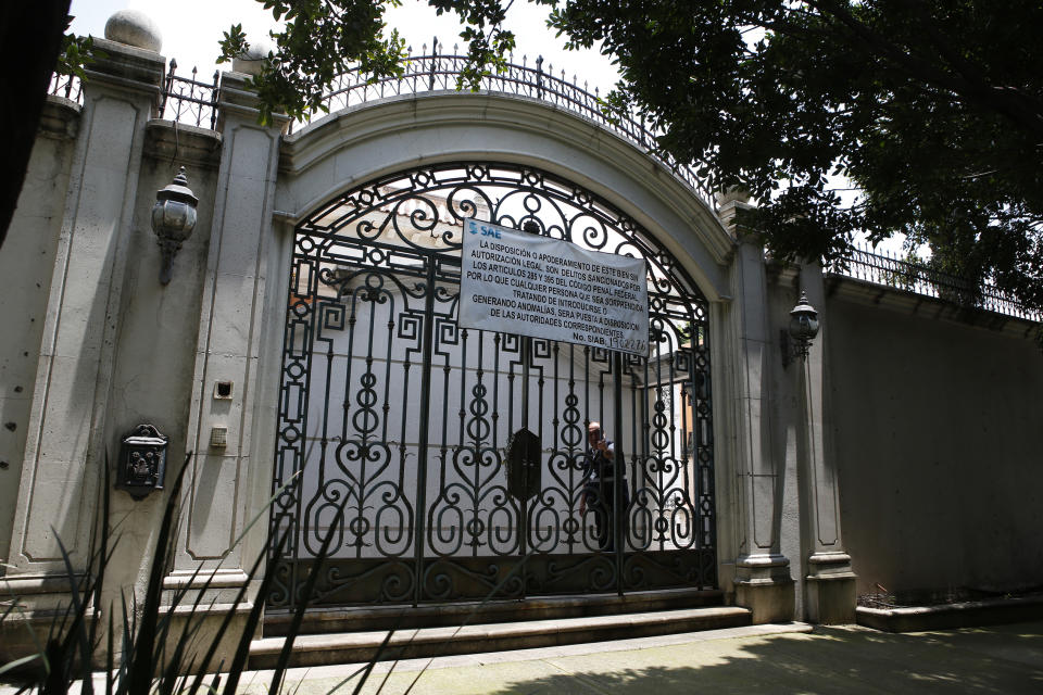 The entrance gate to the mansion of Chinese-Mexican businessman Zhenli Ye Gon during a media tour in Mexico City, Tuesday, July 30, 2019. The federal government said Monday it will hold an Aug. 11 auction for the Mexico City mansion worth $5 million (95 million Mexican pesos) that previously belonged to the suspected drug trafficker. (AP Photo/Ginnette Riquelme)