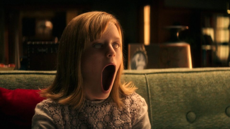Lulu Wilson has milky eyes and an exaggerated open mouth in Ouija: Origin of Evil