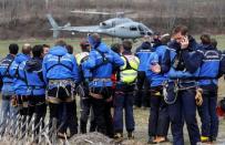 French Police and Gendarmerie Alpine rescue units gather on a field as they prepare to reach the crash site of an Airbus A320, near Seyne-les-Alpes, in the French Alps, March 24, 2015. REUTERS/Jean-Paul Pelissier