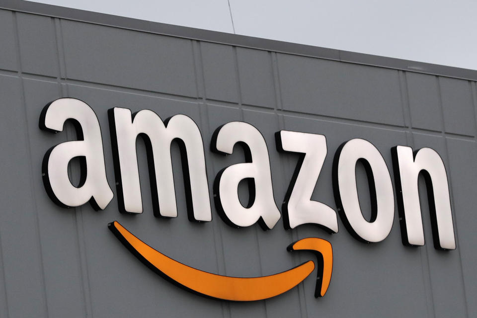 A sign is lit on the facade of an Amazon fulfillment center on Staten Island in New York. The company plans to hire another 100,000 new workers in their fulfillment centers to fill increased customer demand during the coronavirus outbreak in which many Americans are working from home and discouraged from going out. (Photo: ASSOCIATED PRESS)