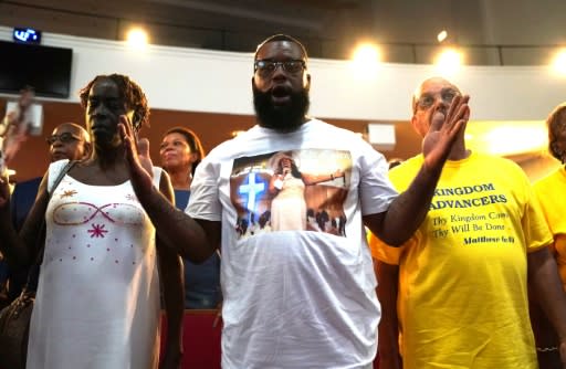 Fans of Aretha Franklin pray during the Sunday service at New Bethel Baptist Church in Detroit