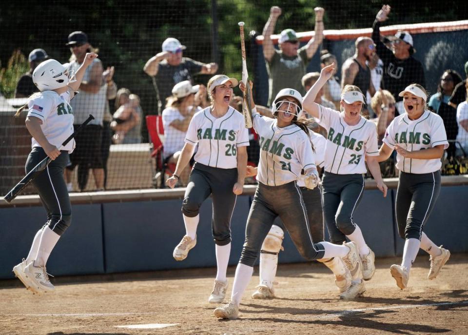 Dixon players celebrate a home run by Caitlyn Hendershot during the Sac-Joaquin Section Division IV softball championship game against Central Catholic on Saturday, May 25, 2024, at Cosumnes River College.