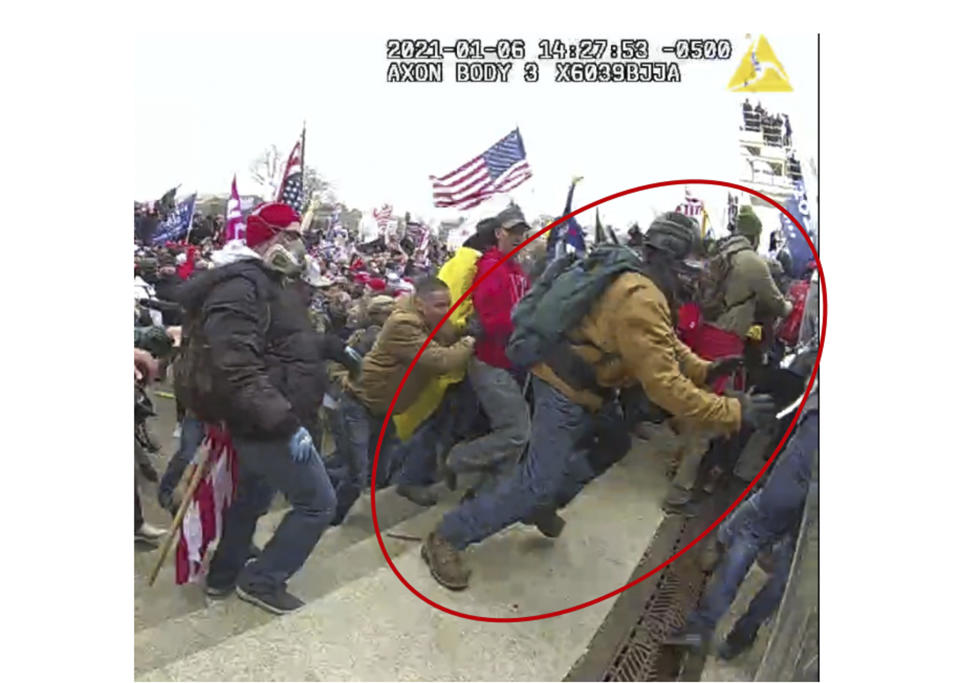 This image from police body-worn camera video, contained and annotated in the Justice Department's government's sentencing memorandum supporting the sentencing of Jeffrey Sabol shows Sabol at the U.S. Capitol on Jan. 6, 2021, in Washington. During the course of an attack on police officers, Sabol ripped the baton out of the hands of a fallen officer, leaving him unable to defend himself against assaults by other rioters. Sabol then helped his co-defendants drag a second officer into the crowd, where that officer was also beaten by rioters. (Department of Justice via AP)