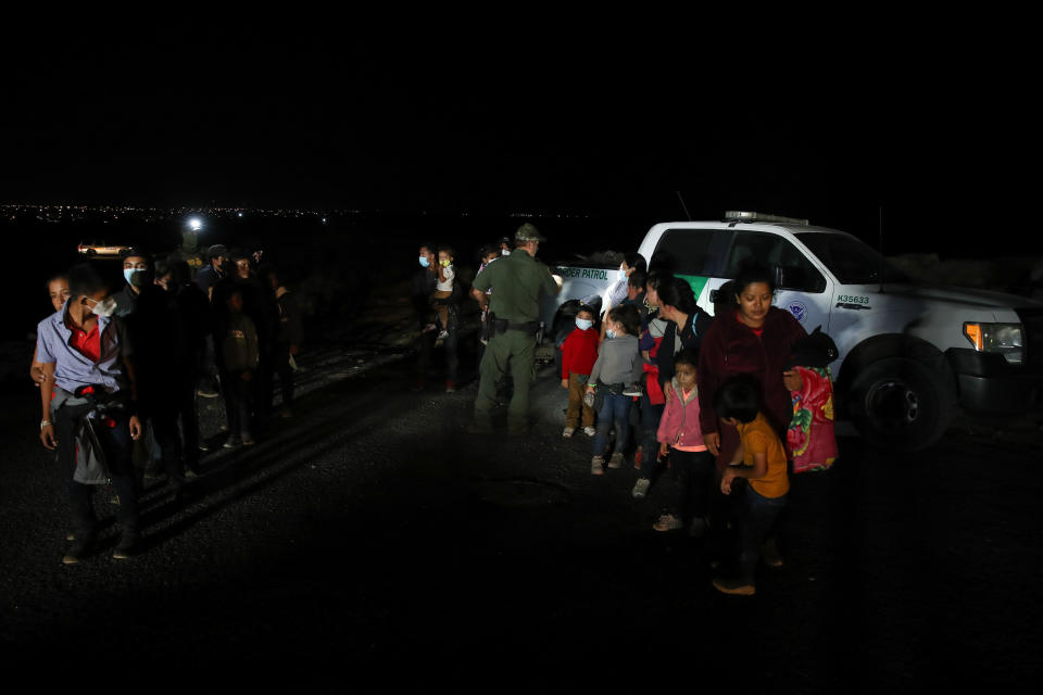 Hundreds of migrants from Honduras, Guatemala and El Salvador wait to register names upon their arrival in the U.S. after crossing the Rio Grande river from Mexico aboard, in Roma, Texas, United States on April 9, 2021.  / Credit: Tayfun Coskun/Anadolu Agency via Getty Images