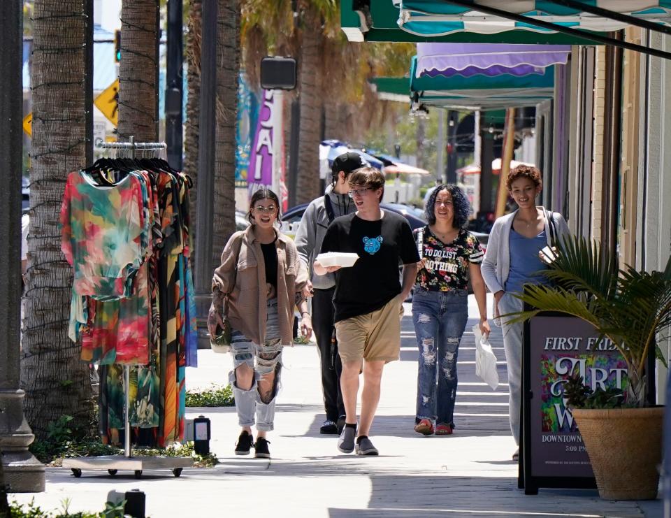 Shoppers walk along Beach Street in Daytona Beach, Thursday, April 25, 2024.