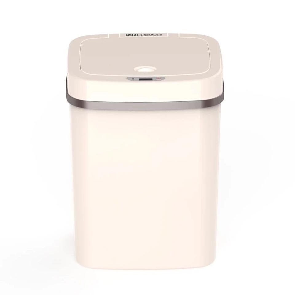 cream colored no-touch bathroom waste basket