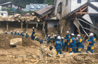 <p>Emergency teams rest outside of structural damage caused by heavy rains, July 9, 2018, in Hiroshima, Japan. (Photo: Haruka Nuga/AP) </p>