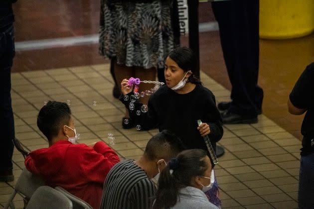 Asylum seekers fill out paper work and receive shoes and other items inside the Port Authority bus terminal in New York on Sept. 9, 2022. 