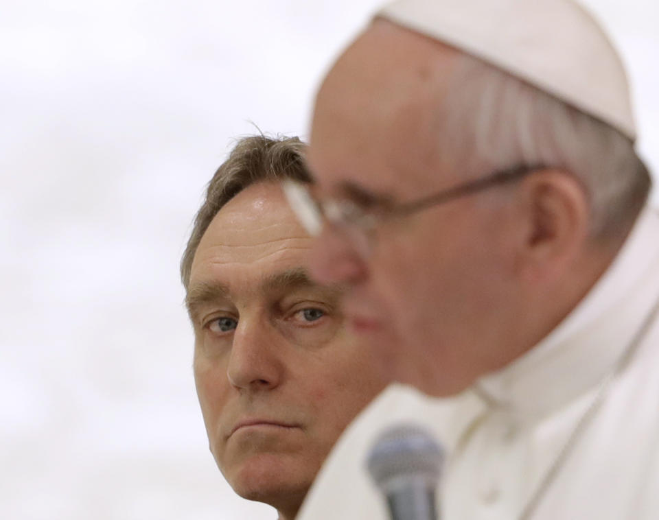 FILE - In this Feb. 4, 2017 file photo, Archbishop Georg Gaenswein looks at Pope Francis delivering his message during an audience at the Paul VI Hall, at the Vatican. The Vatican press office denied Wednesday Feb. 5, 2020 that Gaenswein had been suspended as head of the papal household following his role in a controversial book on priestly celibacy co-written by Emeritus Pope Benedict XVI. It said his absence from Pope Francis’ private and public audiences for the past several weeks was “due to an ordinary redistribution of the various commitments and duties of the prefect.” (AP Photo/Andrew Medichini)