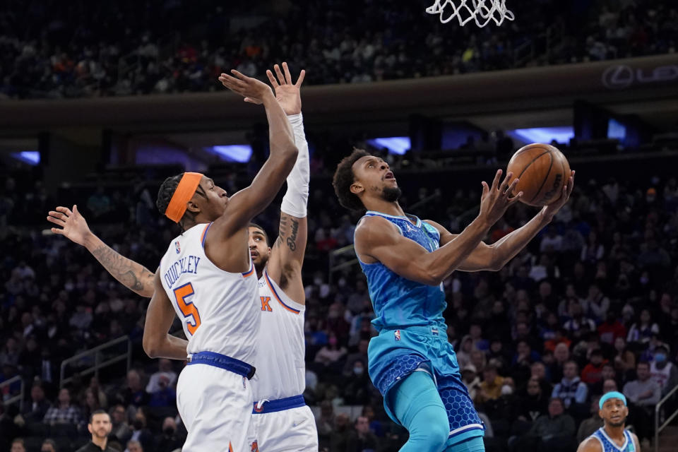 Charlotte Hornets guard Ish Smith (10) shoots past New York Knicks guard Immanuel Quickley (5) during the first half of an NBA basketball game, Monday, Jan. 17, 2022, in New York. (AP Photo/John Minchillo)