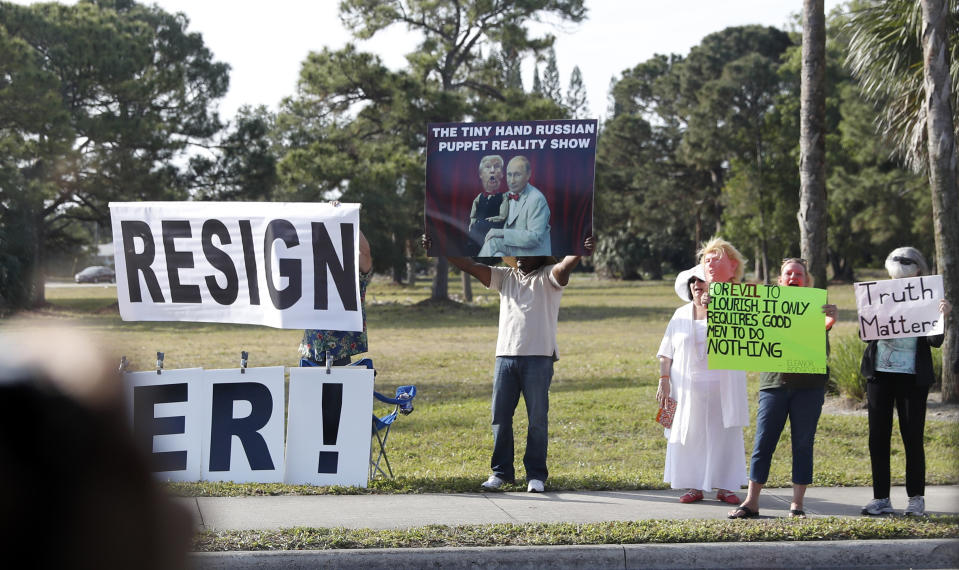 Protesters gather as the motorcade for President Donald Trump arrives at at the Trump International Golf Club, Saturday, April 8, 2017, in West Palm Beach, Fla. (AP Photo/Alex Brandon)