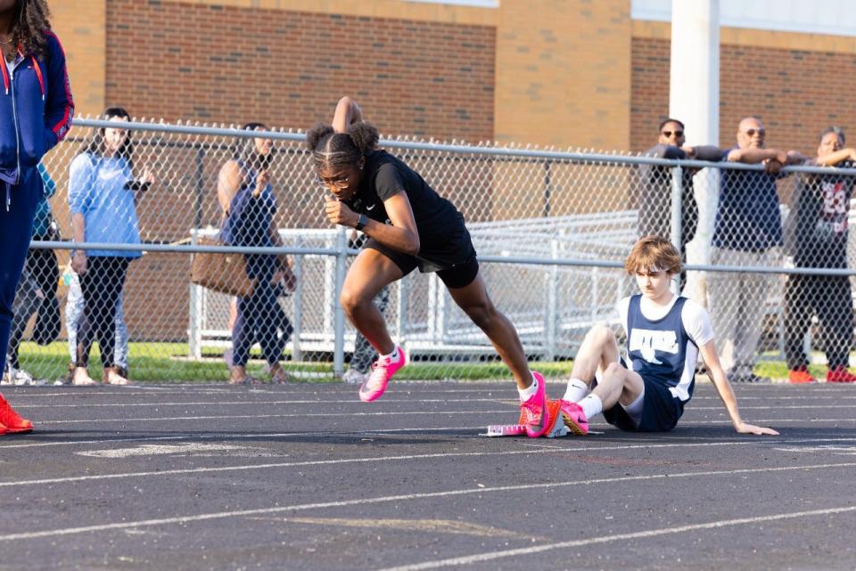 Akron native Miniya Mitchell runs for the I Promise School's girls track and field team last season.