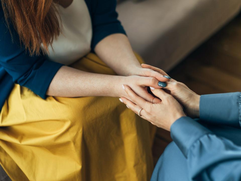 A couple hold hands