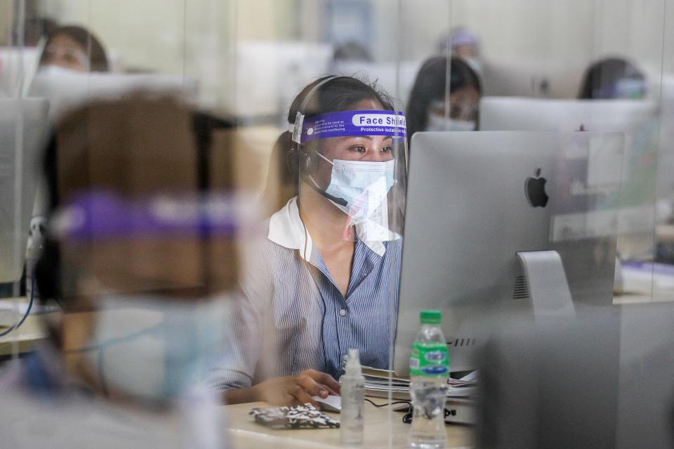 FILE PHOTO: Licensed teachers answer calls to assist students inside the Tele-Aral Center in Manila, the Philippines on Oct. 6, 2020. (Photo: Xinhua/Rouelle Umali via Getty Images)