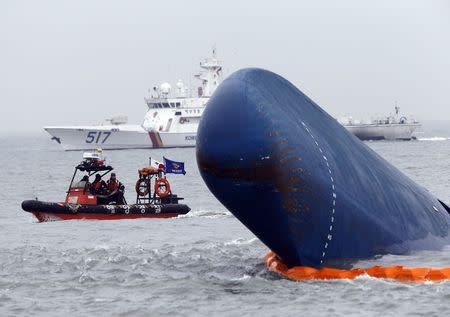 Rescue boats sail around the South Korean passenger ship "Sewol" which sank, during their rescue operation in the sea off Jindo, in this April 17, 2014 file photograph. REUTERS/Kim Kyung-Hoon