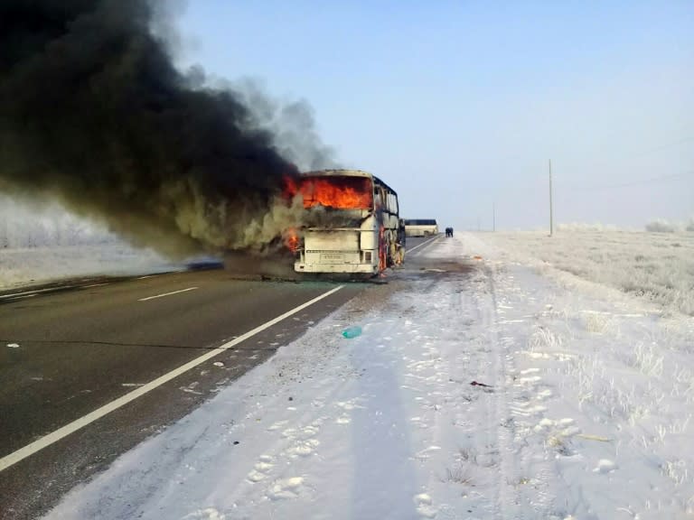 A burning bus on a road in the region around the city of Aktobe