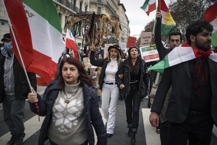 People demonstrate in Lyon, central France, Sunday, Jan. 8, 2023. Hundreds of people marched Sunday in France to honor an Iranian Kurdish man who took his own life in a desperate act of anguish over the nationwide protests in Iran. Police estimated the size of the crowd that gathered for Mohammad Moradi at about 1,000 people. They marched in the city of Lyon, where the 38-year-old Moradi took his own life in December, drowning in the Rhone river. (AP Photo/Laurent Cipriani)