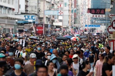 Anti-extradition bill protesters walk through Sham Shui Po neighbourhood in Hong Kong