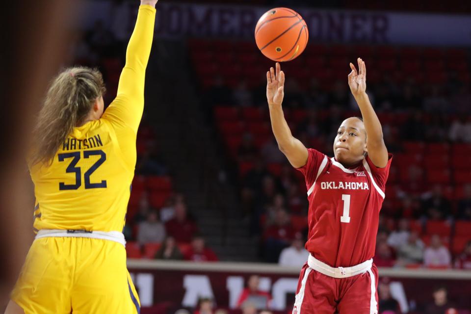 Oklahoma Sooners guard Nevaeh Tot (1) shoots a basket over West Virginia Mountaineers guard Kyah Watson (32) during a women's college basketball game between the University of Oklahoma Sooners (OU) and the West Virginia Mountaineers at Lloyd Noble Center in Norman, Okla., Saturday, Feb. 4, 2023. 